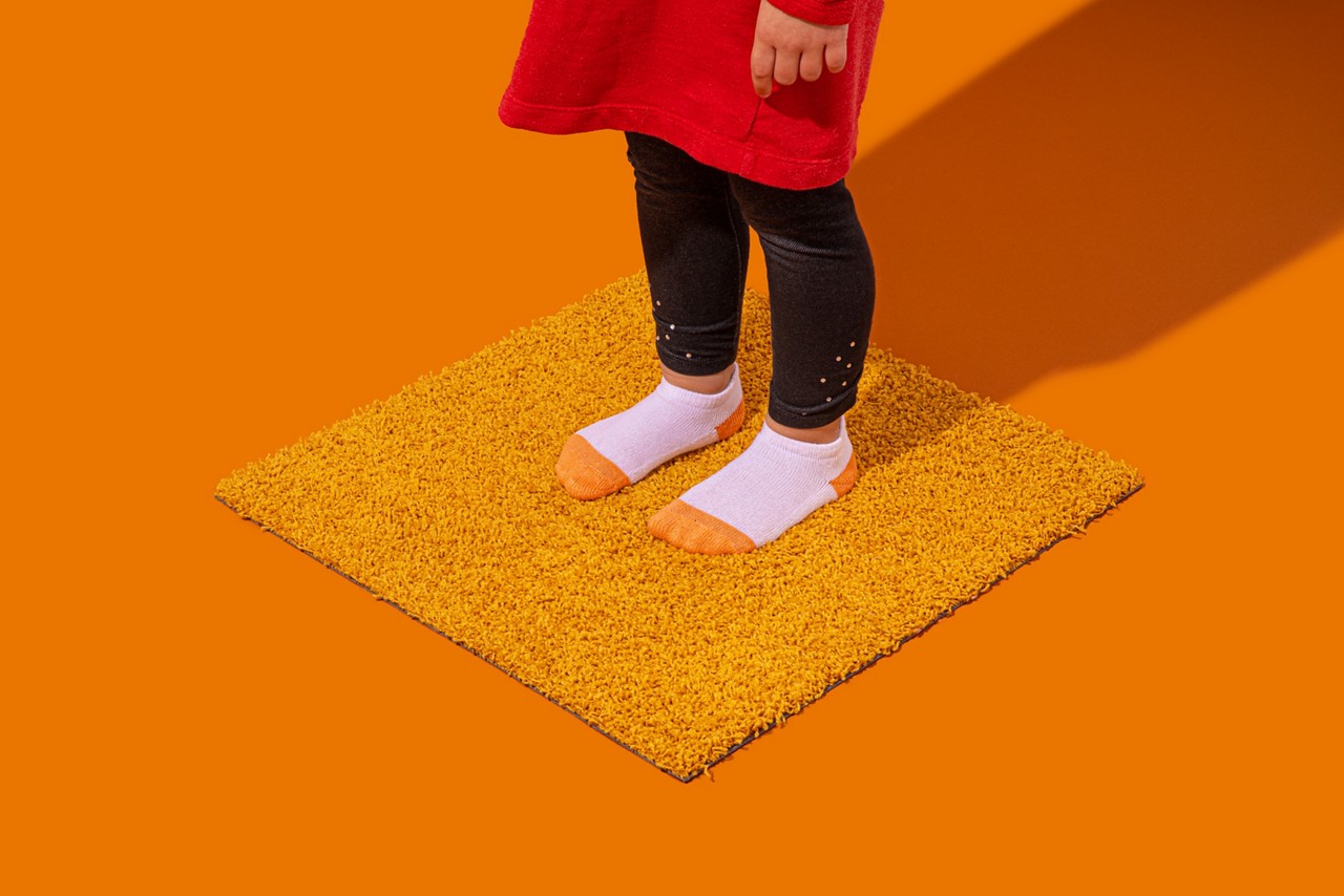 kid's feet standing on carpet