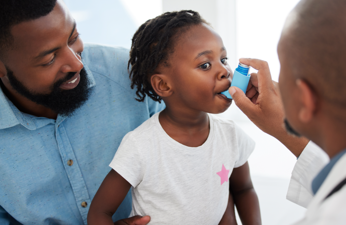 Young girl getting an inhaler from a doctor | Spring allergies