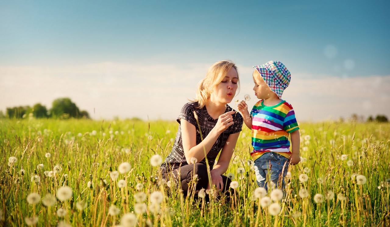 mother and son in a dandelion field