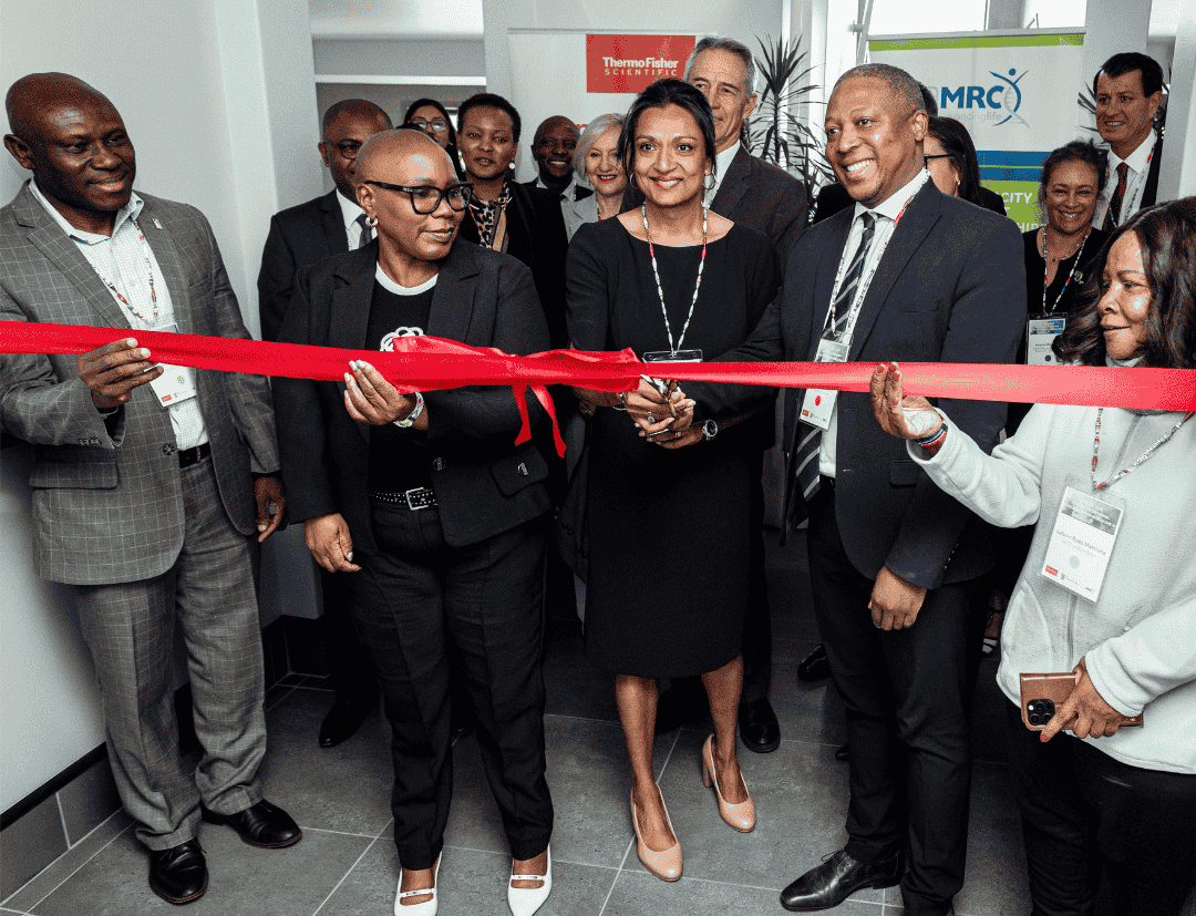 Ribbon Cutting from left to right: Prof Pesscal Bessong from the University of Venda, Nomalungelo Gina, Deputy Minister at DSTI, Urmi, Prof Ntusi, CEO and President at SAMRC (behind them is Dr Mlungisi Cele, DG at DSTI, Futhi, Prof Glenda Gray (former SAMRC President and CEO, now Professor at University of Witwatersrand), Dr Nicholas Crisp, Deputy Director at Department of Health and Marcin. Last row is Pritika Ramharack, Senior Scientist from SAMRC and Dr Mongezi Mdhluli, Chief Research Operations Officer at SAMRC.