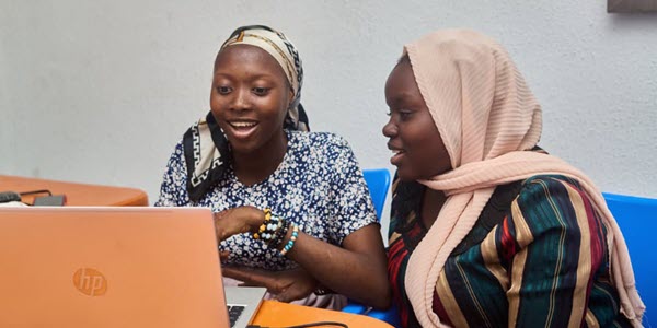   Bella (right) works with an instructor during her training program with Project HOPE.