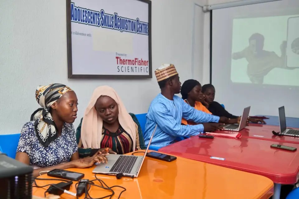   Bella (second from left) learned soft skills, such as public speaking, and graphic design through a local training program provided by Project HOPE.